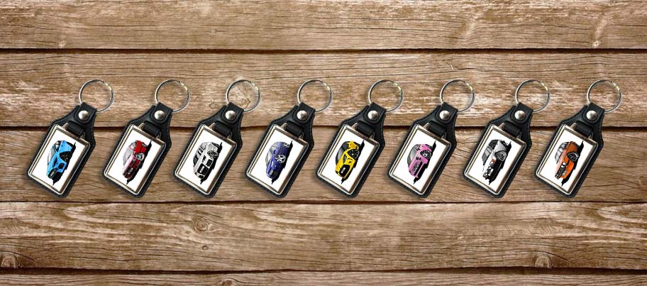 a row of leather look keyrings hanging on some wood