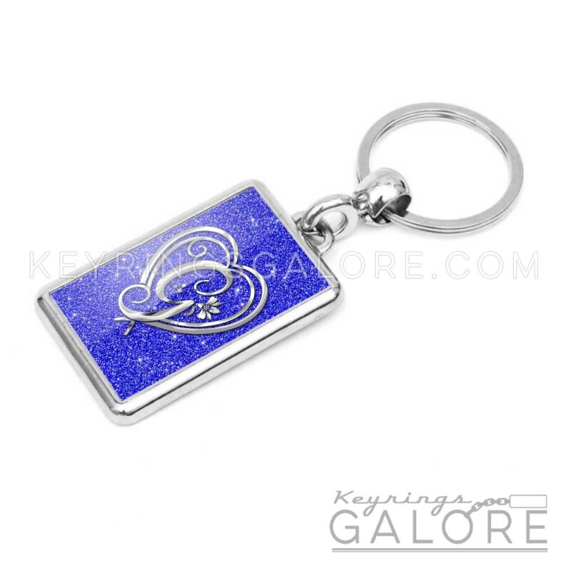 chrome plated key ring key chain personalized with monogram silver initial and blue glitter background