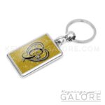 chrome plated key ring key chain personalized with monogram black initial and gold glitter background