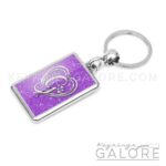 chrome plated key ring key chain personalized with monogram silver initial and purple glitter background