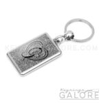 chrome plated key ring key chain personalized with monogram black initial and silver glitter background